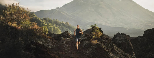 Man running on a trail in the mountains, representing active lifestyles supported by Supple joint health supplements with glucosamine, chondroitin, and boswellia.