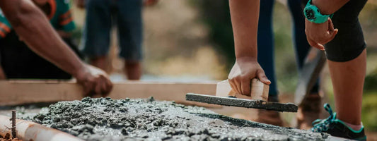 Woman laying concrete while wearing a watch, representing strength, durability, and joint support with Supple joint health supplements.